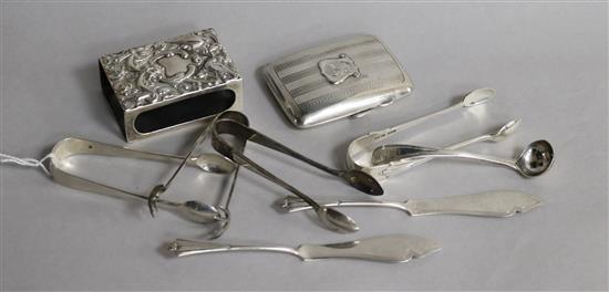 A silver cigaretter case, a silver match sleeve, a pair of silver butter knives, four pairs of silver sugar tongs and a silver ladle.